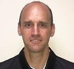Headshot of a bald man