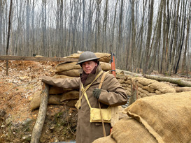 WW1 soldier standing in a british trench.