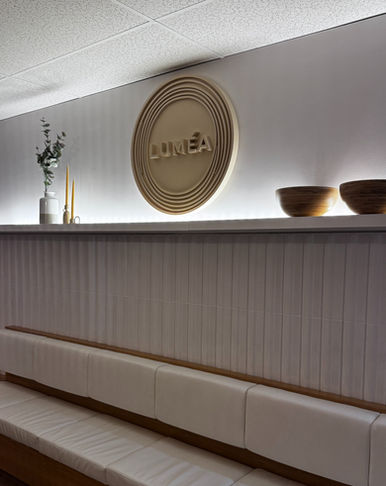 A circular 3D Luméa logo installed on a waiting room wall, manufactured by Tmoov3D in Gatineau.