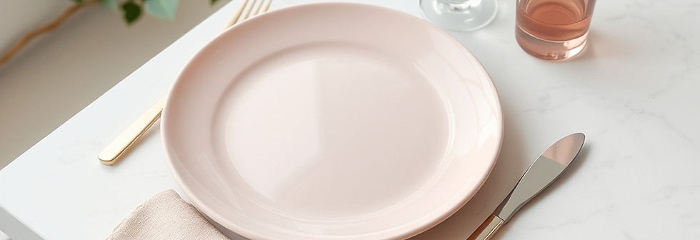a granite white table setting with a light pink plate and utensils and normal glass cup .j