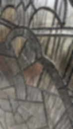 Thumbnail: A cathedral arch window painting with weathered stained glass in shades of rust, gold, brown and gray,