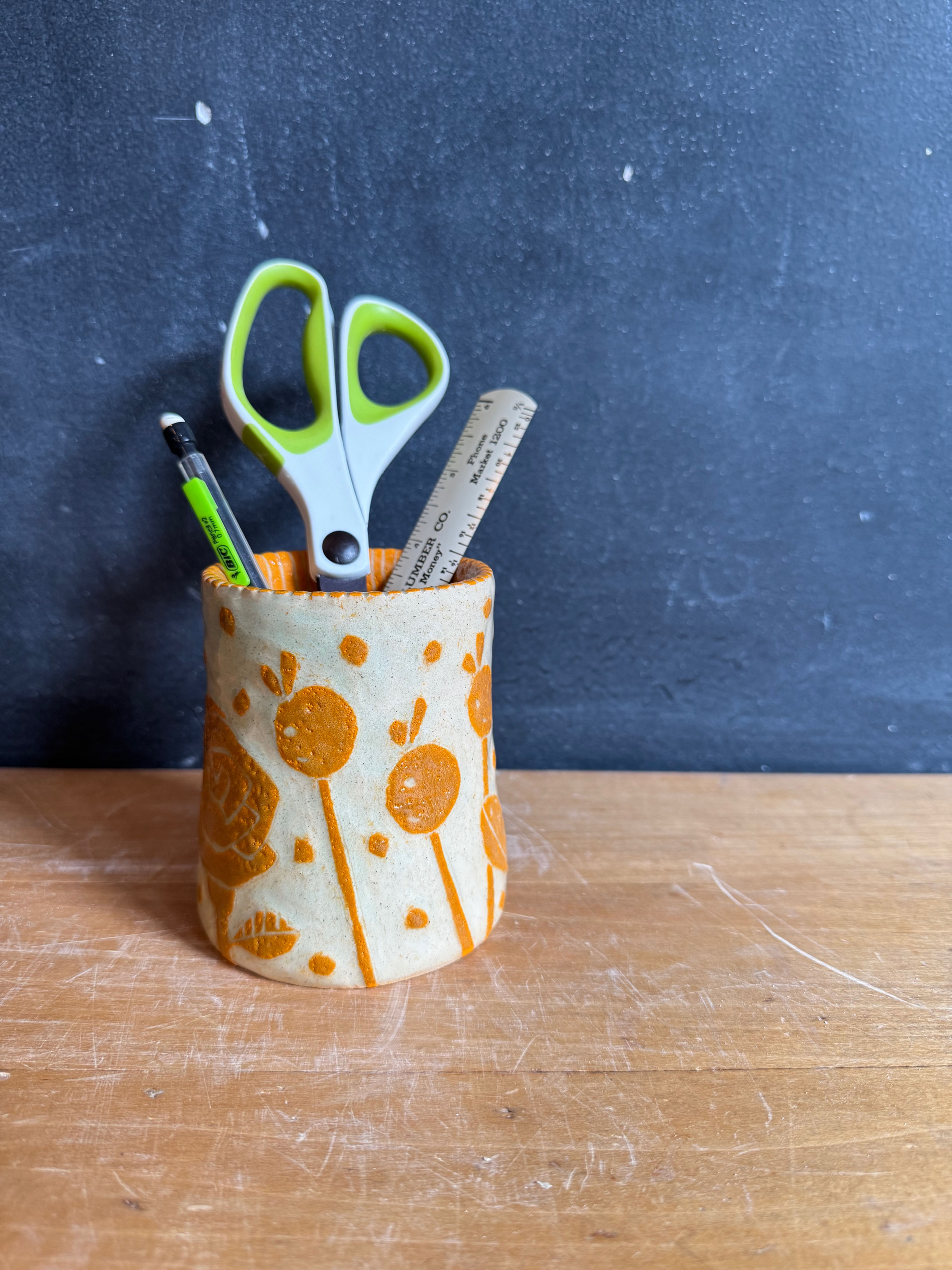 Orange baby vase/cup.