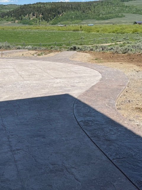 Close up photo of stamped concrete with green hills in the background