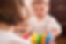 mom-giving-toddler-boy-toy_g3udf9