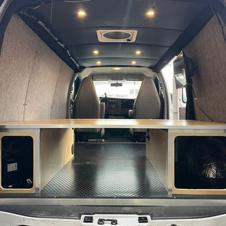 2022 GMC Savana 2500 build interior with custom storage platform and LED ceiling