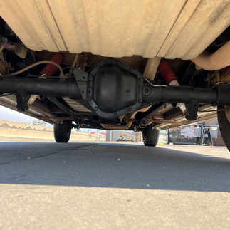 Undercarriage of 1988 Ford Econoline showing suspension and rear axle.