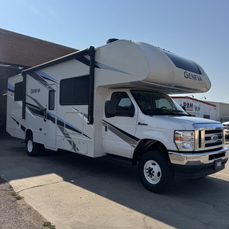 Passenger 3/4 view of Thor Geneva Class C rv with 6" lift kit