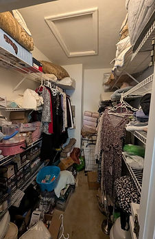 Before photo of a cluttered walk-in closet