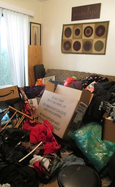 Before photo of a very cluttered guest bedroom