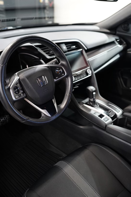 Interior car detailing showcasing restored leather seats