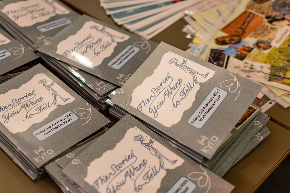 6 piles of programmes spread across the table at 'The Stories You Want to Tell' premiere.