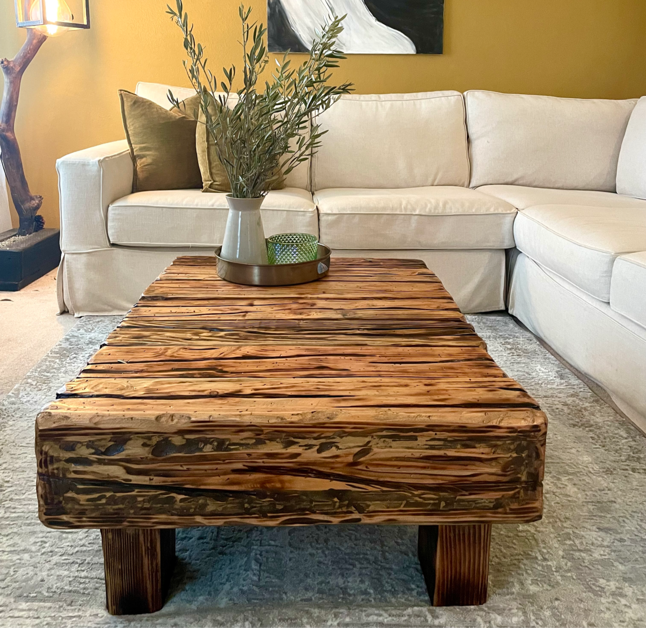 Rustic coffee table handcrafted from thick douglas fir lumbers and with a blowtorched light brown wood tone.
