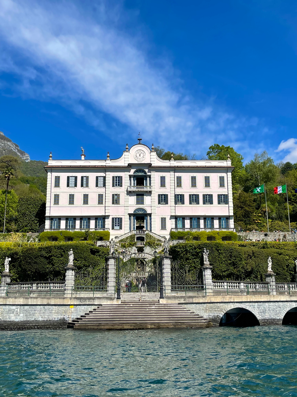 Behold Villa Carlotta, a neoclassical masterpiece poised on the shores of Como Lake, its pink façade gleaming in the Italian sun against a backdrop of majestic mountains and clear blue skies. Known for its art collections and botanical garden, Villa Carlotta offers a cultural voyage through its illustrious past, dating back to the late 17th century. Accessible via our exclusive boat rentals, it invites visitors to explore its opulent halls that once entertained royalty and its immaculate gardens that have been featured in many a film. A day at Villa Carlotta is a day spent walking through history, beauty, and the grandeur of Como.