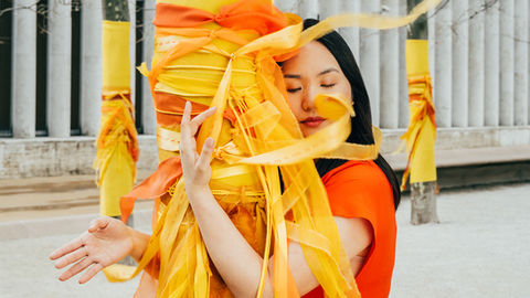 person holding onto tree branch