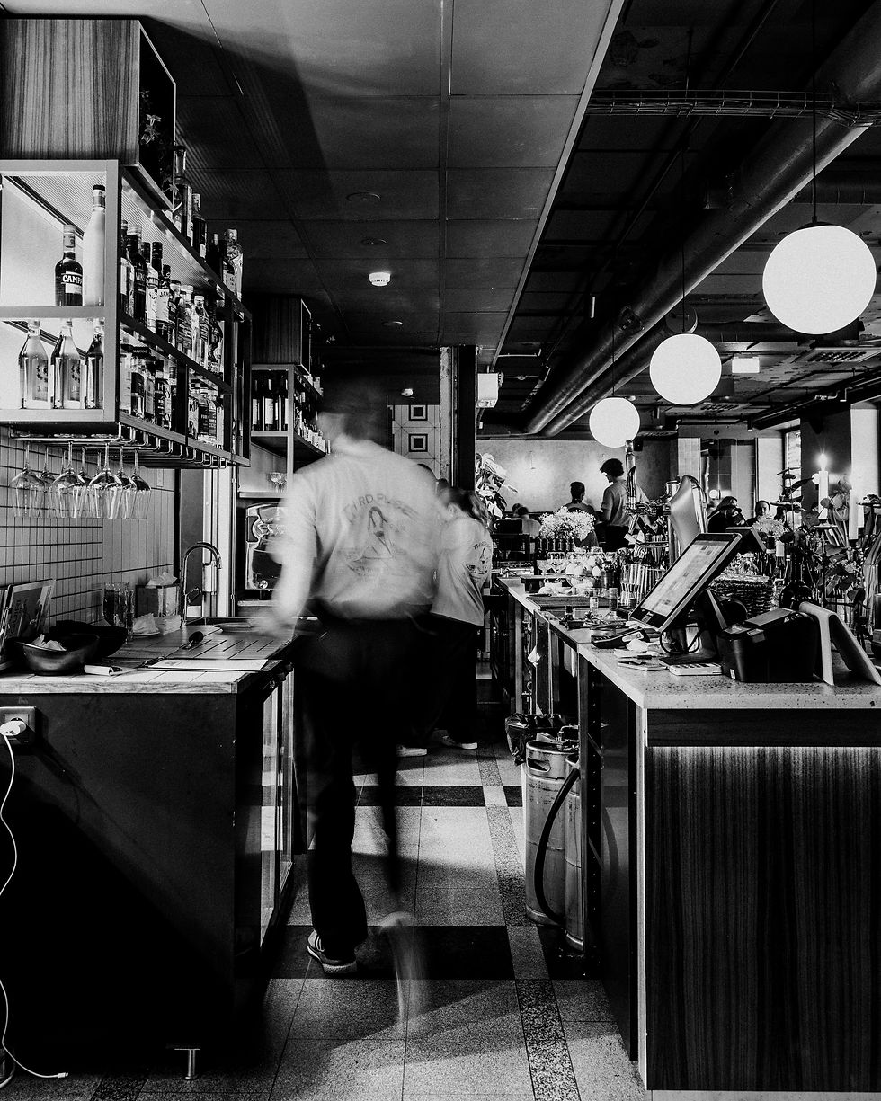 A relaxed Helsinki restaurant with a cozy bar, vinyl music playing at the background.