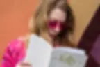 A blonde woman reading Folly Magazine