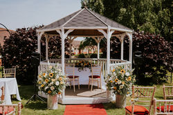 The wedding pavilion at Cantley House Hotel is flanked by two large milk churns is filled with sunfl
