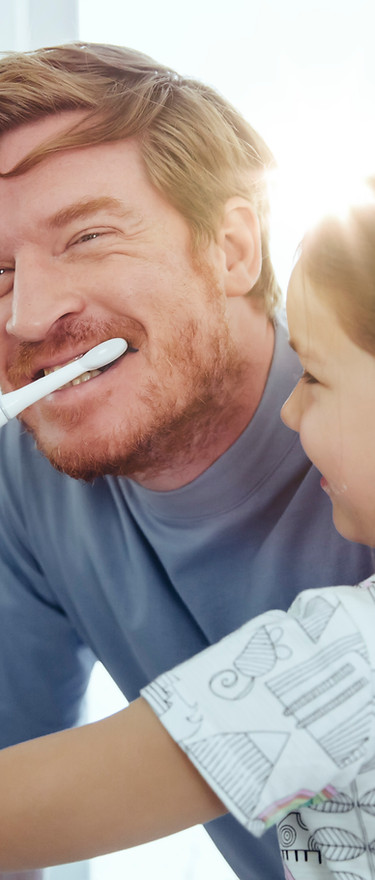 Girl Brushing Dad's Teeth