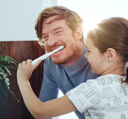 Girl Brushing Dad's Teeth