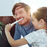 Girl Brushing Dad's Teeth