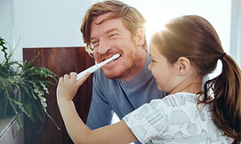 Girl Brushing Dad's Teeth