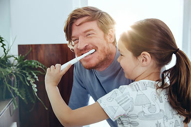 Girl Brushing Dad's Teeth