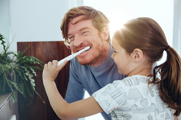 Girl Brushing Dad's Teeth