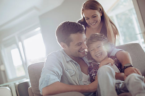 Happy Family Enjoying Their New Home Protected by Impact Doors & Windows