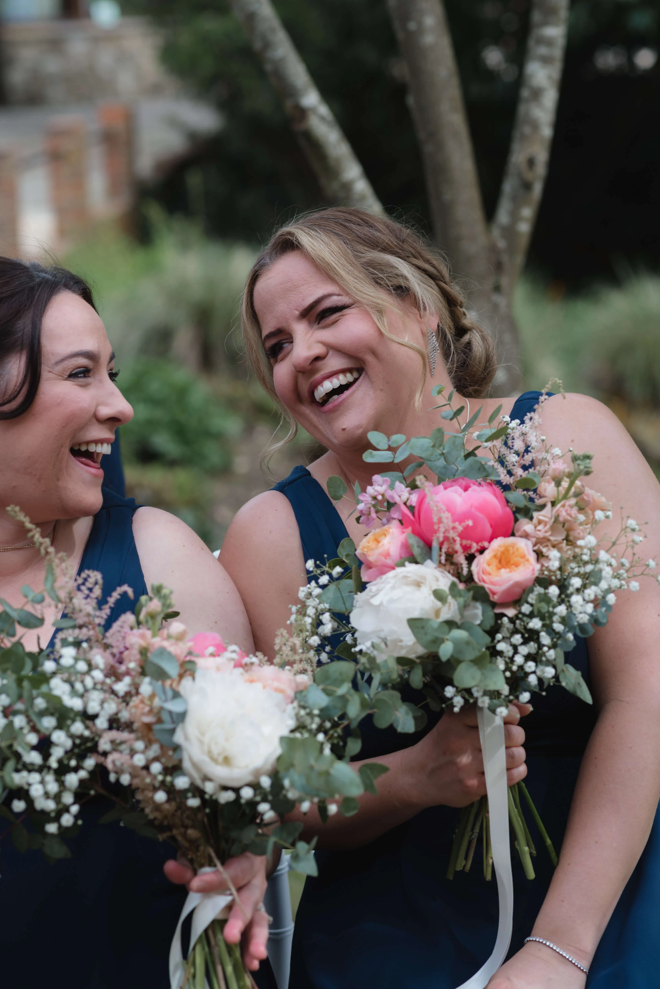 Two bridesmaids laughing at The Ravenswood Hotel