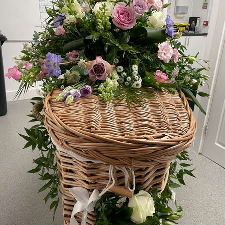 Wicker casket with garland
