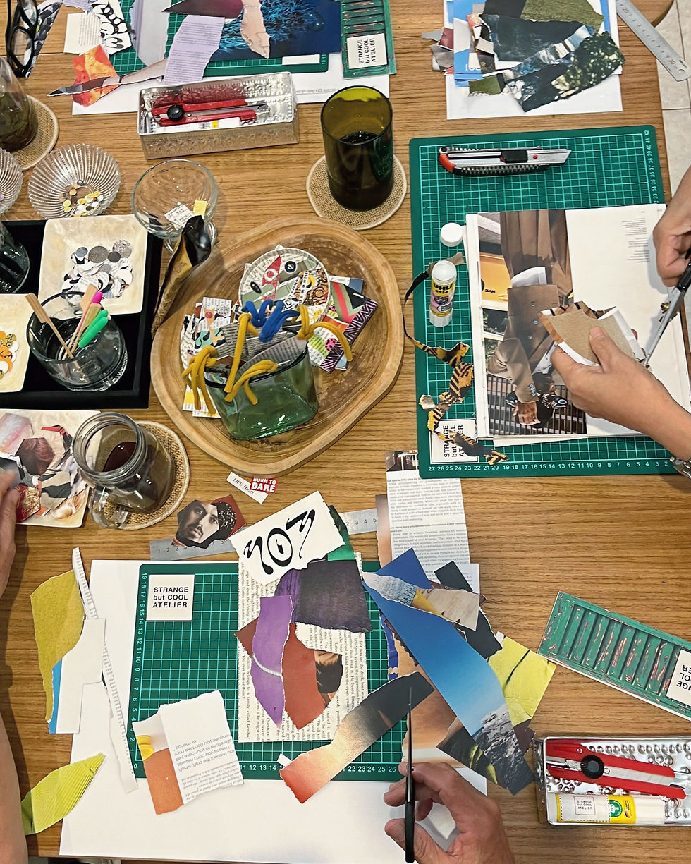 Collage workshop table at StrangebutCool Atelier Bali with magazine cuttings, scissors and cutting mats