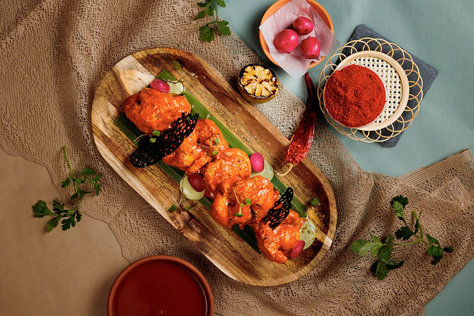 Juicy Texas Chicken Kebab plated with fresh herbs at Indian restaurant in Cupertino