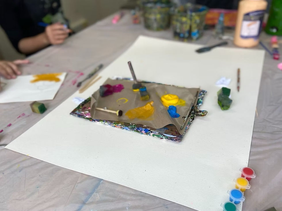 Paint palette in the centre with various painting tools, brushes, sponges and more.