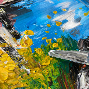 A close up of knife painting, with blue, yellow and green streaks.