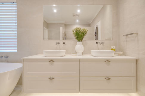 Modern bathroom renovation in Perth with double vanity, vessel sinks, and a minimalist design by Elite Makeovers.