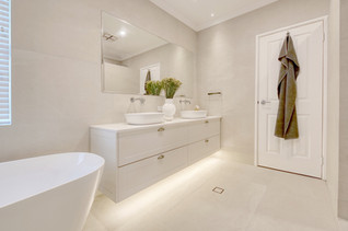 Elegant bathroom transformation in Perth with a freestanding bathtub, floating vanity, and ambient lighting by Elite Makeovers