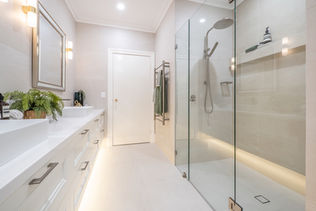 Spacious walk-in shower with glass screen and recessed LED lighting beside double vanity – Churchlands, Perth