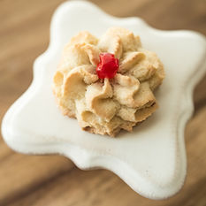 almond cookie in a star shape with cherry