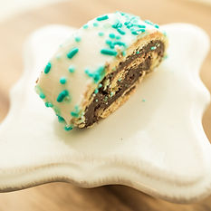 fudge swirl cookie with white icing and blue sprinkles