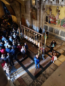 Birds eye view of the Stone of Unction, or the Stone of Anointing in the church of the Holy Sepulcher in Jerusalem. People admire the Holy significance and line up to view the Holy Sepulcher.