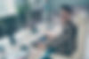 Photo of happy cheerful coder dressed eyewear writing keyboard web designing indoors workp
