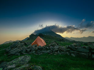 Where should your tent be pitched while hiking?