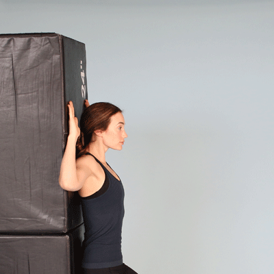Chin tuck and arm wall slide.gif