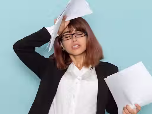 A woman holds a stack of papers, frustrated with how long it's taking to get them all signed.