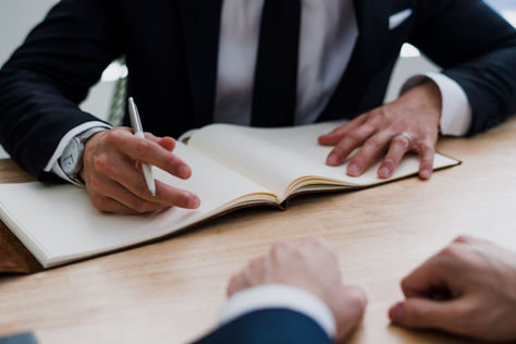 A notary explains to a signer all the information they're about to fill out in their official Notary Journal.