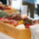 Event food display featuring charcuterie and cheeses and grapes