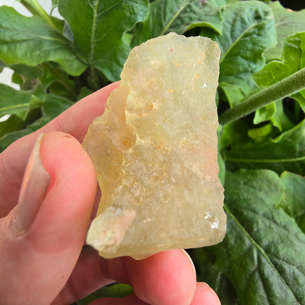 Thumbnail: Yellowish-green Moldavite stone held in hand