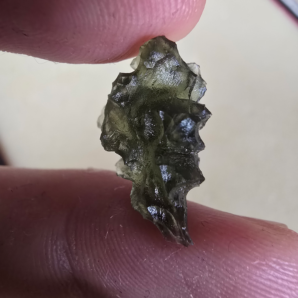 Thumbnail: Rough Moldavite 1.65g held in fingers