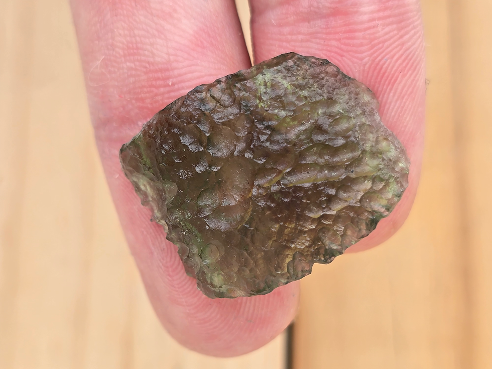 Thumbnail: Raw Moldavite held in fingers