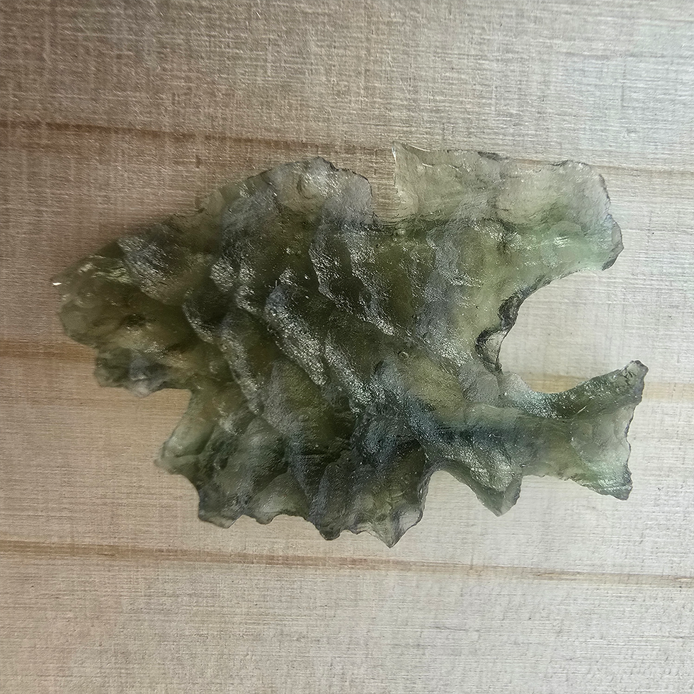 Thumbnail: Translucent Libyan Desert Glass pendant on wood